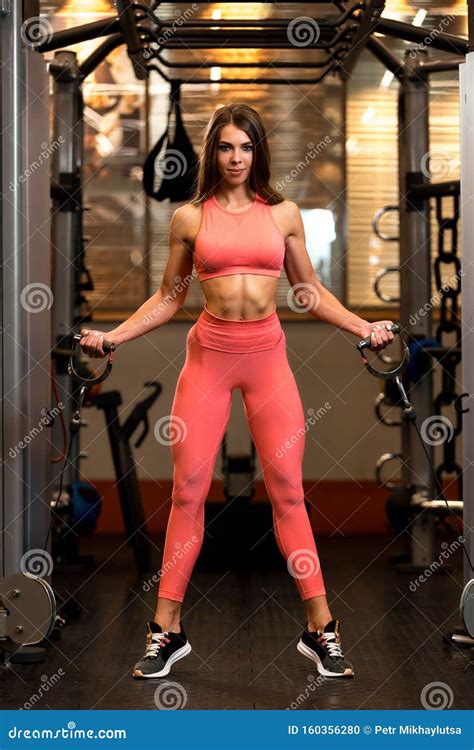 Fitness Brunette Woman Is Doing Exercises On Crossover In The Gym