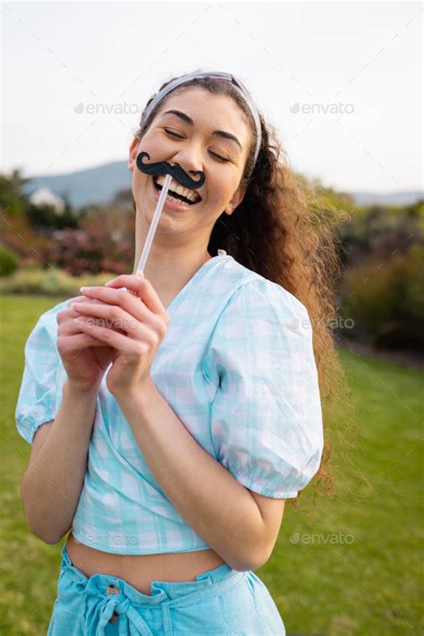 Portrait of happy caucasian woman with fake moustache Stock Photo by ...