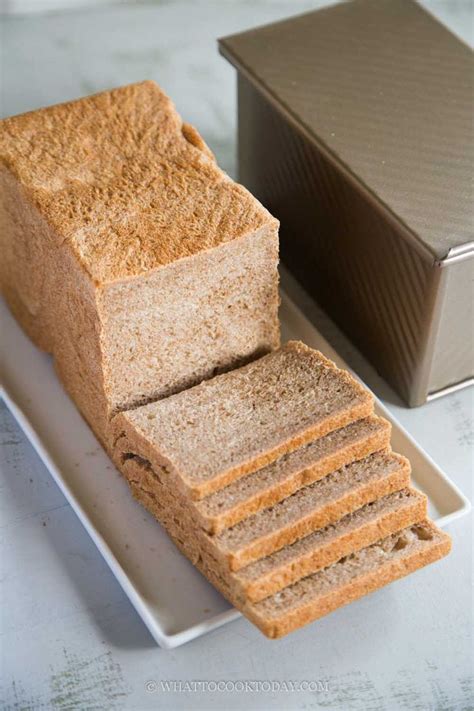 A Loaf Of Bread Sitting On Top Of A White Plate Next To A Brown Box