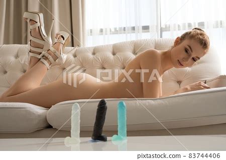 Naked Woman Lying In Room With Sex Toys Stock Photo PIXTA