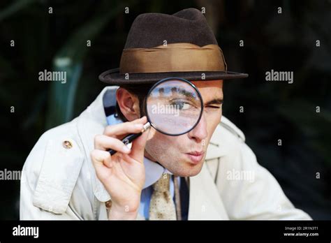 Private Investigator Eye In Magnifying Glass And Portrait Of Man For