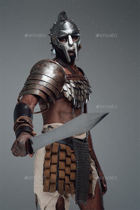 Combative black gladiator with sword in fight pose Stock Photo by fxquadro