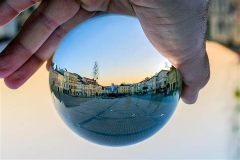 Premium Photo Close Up Of Person Holding Crystal Ball Against Built