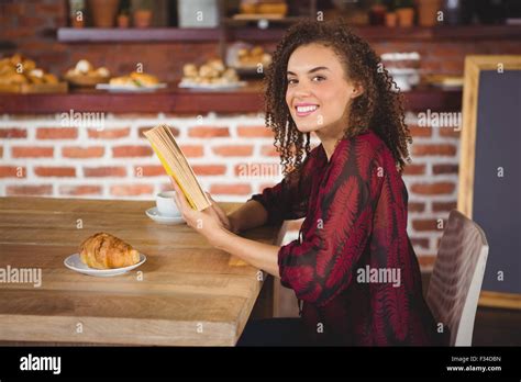 Young happy woman reading a book Stock Photo - Alamy