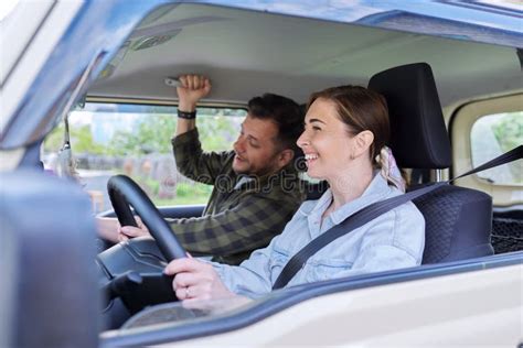 Middle Age Couple Riding In Car Woman Driver Man In Passenger Seat