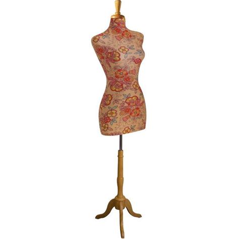 A Mannequin On A Wooden Stand With An Orange And Pink Flowered Dress