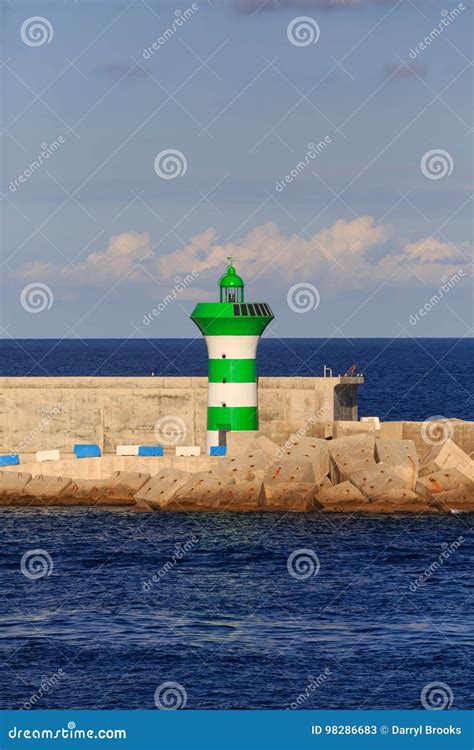 Green And White LIghthouse On Seawall Stock Image Image Of Nautical