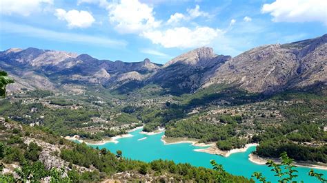 The Beautiful Guadalest Reservoir And Surrounding Mountains In Spain