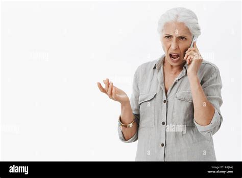 Waist Up Shot Of Pissed And Angry Senior Lady With White Hair Arguing