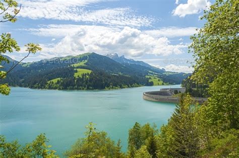 Beautiful Shot Of Lac De L Hongrin Dam With Mountains Under A Clear Sky