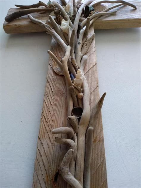 A Cross Made Out Of Driftwood Is Hanging On The Wall