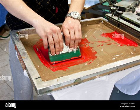 manual screen printing - hand printing t-shirts Stock Photo - Alamy