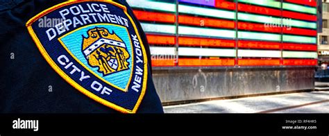 A New York City Police Officer standing in Time Square a lighted ...