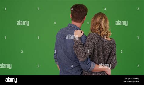 Rear View Of Sweet Loving White Couple Holding Each Other On Green