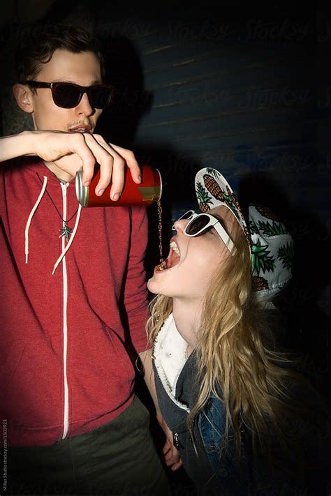 Man Pouring Drink To Woman Mouth By Stocksy Contributor Milles