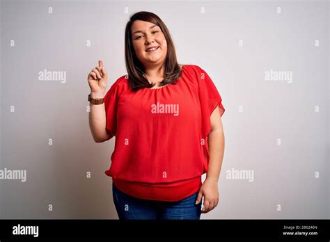 Beautiful Brunette Plus Size Woman Wearing Casual Red T Shirt Over Isolated White Background