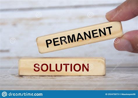 Hand Holding Wooden Blocks With Text Permanent Solution Stock Image