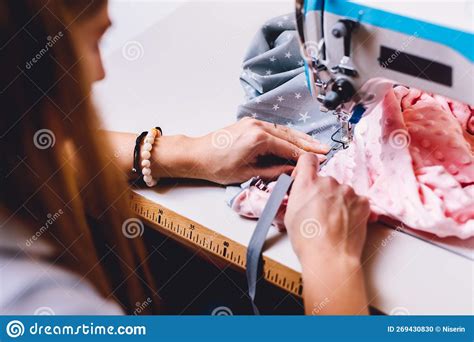 Seamstress Dressmaker Working With Sewing Machine In Workshop Stock