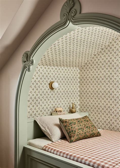 A Bedroom With A Bed Nightstand And Wall Papered Walls In An Arched Niche