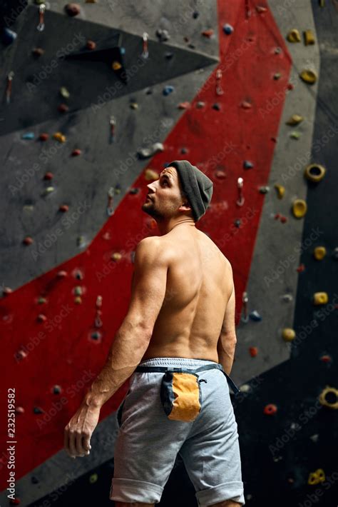 Caucasian Rock Climber With Naked Muscular Torso Equipped With Safety