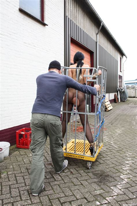 Female Sex Slave Is Wheeled Through A Cobbled Street Before Nipple