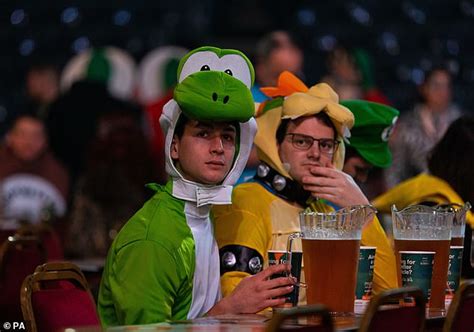 Thousands of boozy darts fans descend on Ally Pally in fancy dress - I
