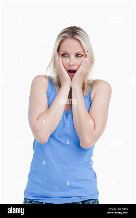 Surprised Blonde Woman Placing Her Hands On Her Cheeks Stock Photo Alamy