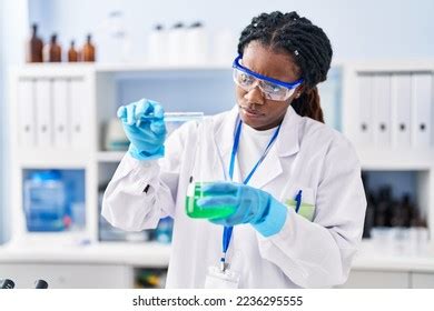 African American Woman Scientist Pouring Liquid Stock Photo 2236295555