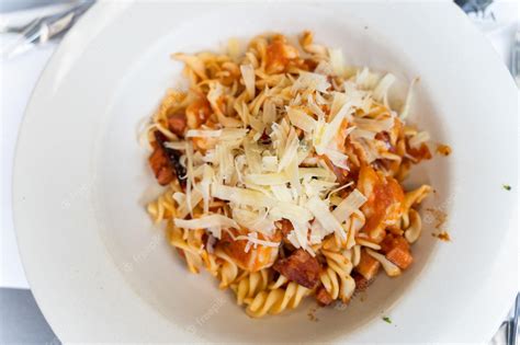 Premium Photo Pasta Spirals With Seafood Meat And Grated Cheese On