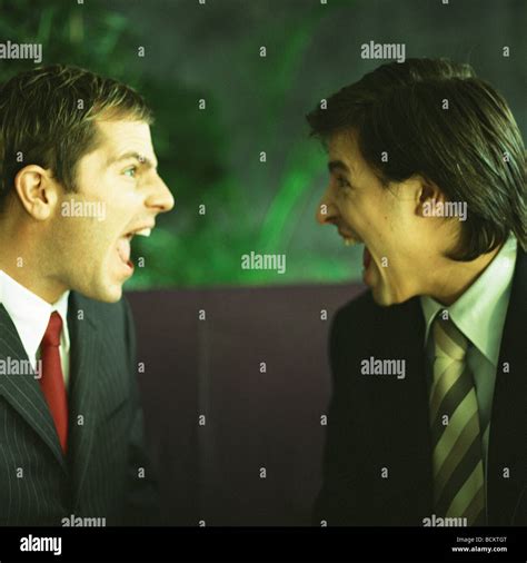 Businessmen yelling face to face Stock Photo - Alamy