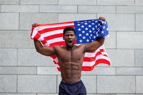 Premium Photo | An africanamerican man with the us flag protests and ...