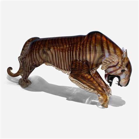 A Glass Figurine Of A Running Tiger On A White Background With Shadow And Light