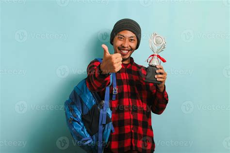 Excited Young Asian Man Student Wearing Backpack Beanie Hat And Red