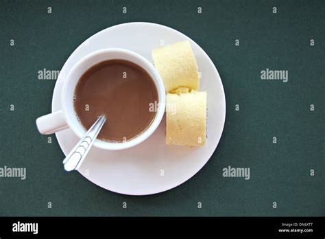 White Cup And Hot Cocoa Inside On Green Background Stock Photo Alamy