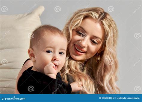 Beautiful Blonde Mother In A Beige Jacket And With A Baby Son Stock Photo Image Of Jacket