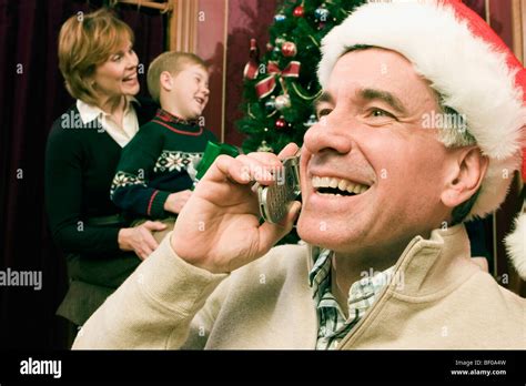 Grandmother And Grandson Behind A Mature Man Talking On A Mobile Phone Stock Photo Alamy