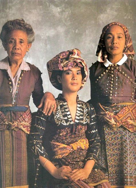 three women in traditional dress standing next to each other with their ...