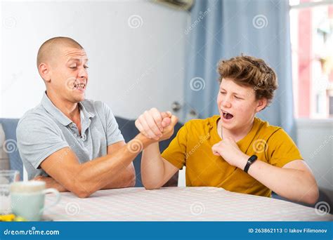 Father And Son Competing In Arm Wrestling Stock Image Image Of Home