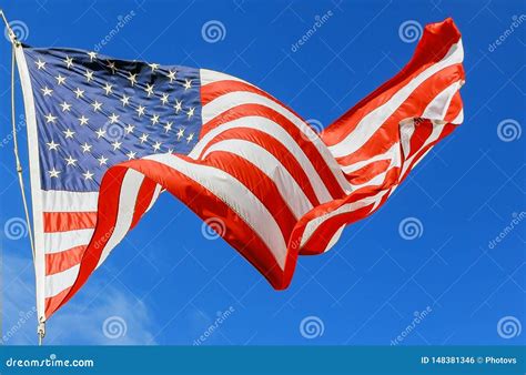 Jumbo Beautiful American Flag On A Flying Against A Sky Stock Photo