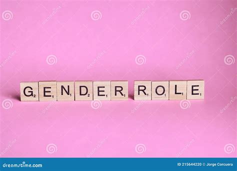 Gender Role Words Represented By Wooden Letter Tiles Isolated On Colour