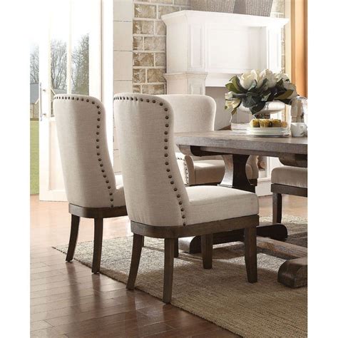 A Dining Room Table With Chairs And A Vase On Top Of It In Front Of A