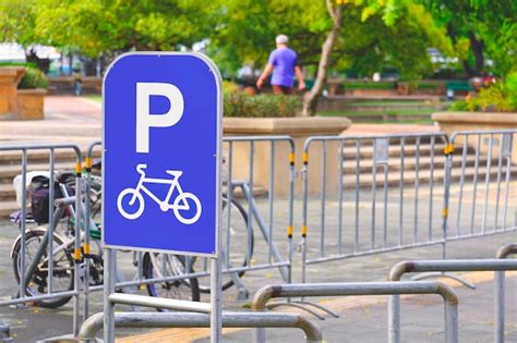 Premium Photo Bicycle Parking Sign With Row Of Steel Bicycle Parking Space In Front Of Public Park