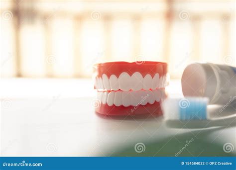 Close Up Denture With Toothpaste Toothbrush On Blurred Background