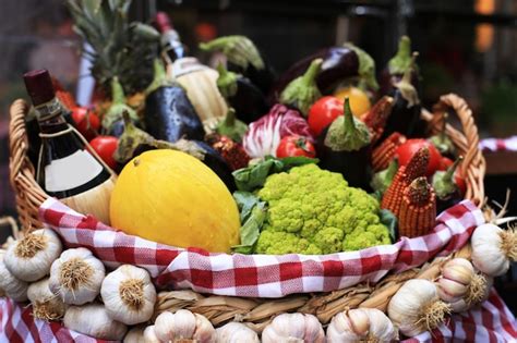 Premium Photo | Vegetables and fruits with herbs and wine in a basket