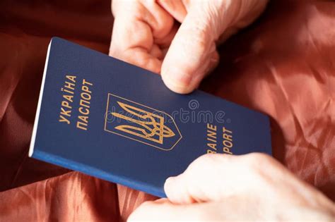 Hands Of An Old Woman Hold A Ukrainian Foreign Passport Ukrainian