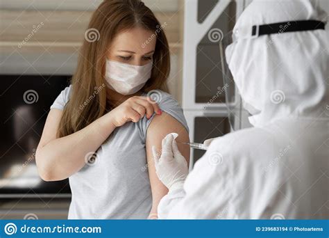 Doctor In Personal Protective Suit Or Ppe Inject Vaccine Shot To