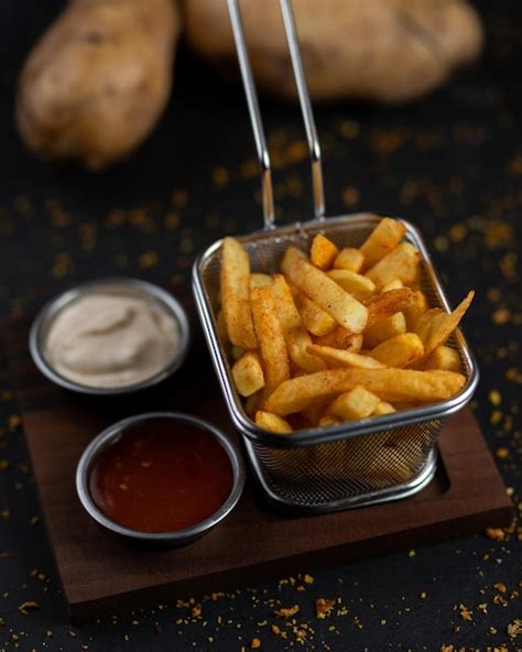 Premium Photo | A basket of fries with a sauce on the side.