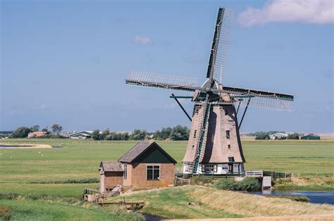 Premium Photo | A windmill in the netherlands with a small house in the ...