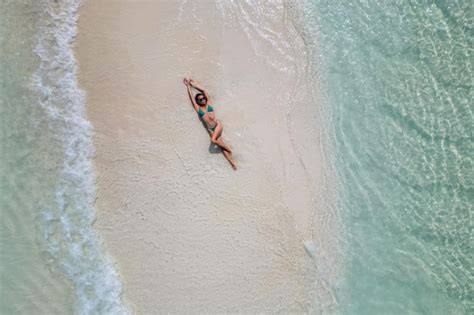 Premium Photo Young Woman Tanning Sunbathing Woman Wearing Bikini At