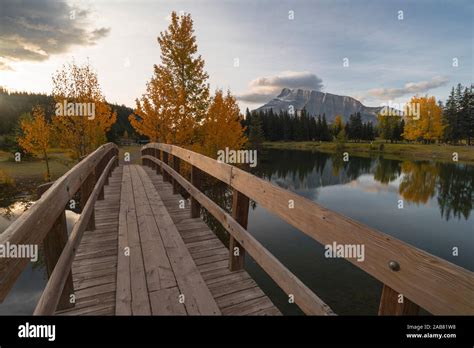 Bridge Over Cascade Pond With Mount Rundle On Horizon In Autumn Banff